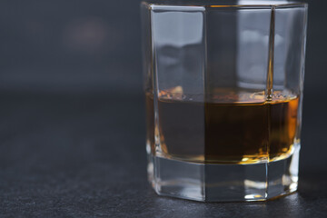 Glass of whiskey on a wooden table in a bar. Bar counter with an alcoholic drink.