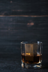 Glass of whiskey on a wooden table in a bar. Bar counter with an alcoholic drink.
