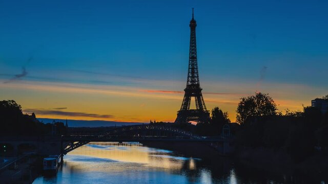 Architecture of Paris with Eiffel Tower, Seine river and Pont Rouelle at dawn