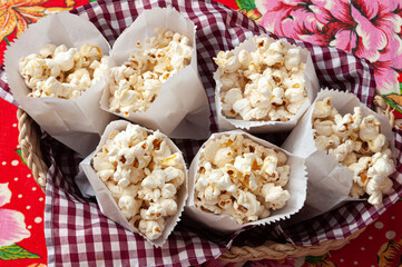 a lot of popcorn in a paper bag and colorful background