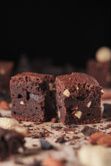 Chocolate brownie with nuts. Sweet and tasty dessert close-up on a wooden table. Soft focus.