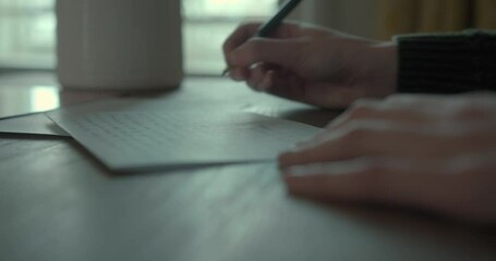  Young woman writing letter at desk