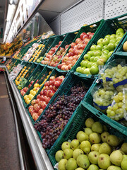 Drawers with assorted vegetables, red and green bell peppers, vegetables on the market