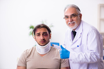 Young face injured man visiting experienced male doctor traumato