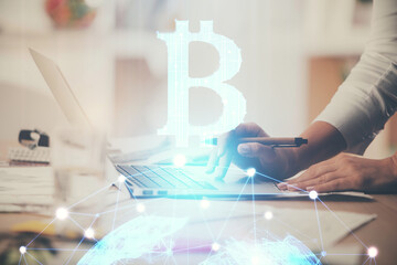 Double exposure of woman hands typing on computer and crypto market theme hologram drawing....