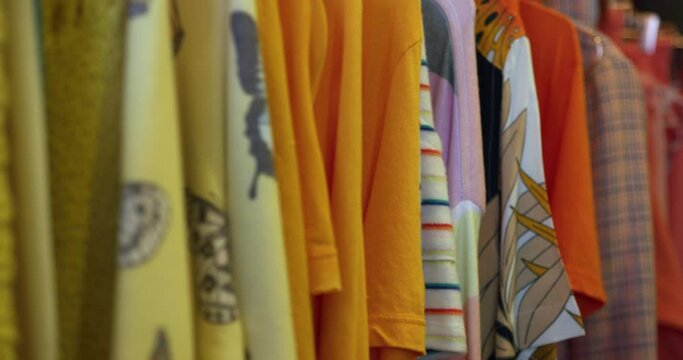 CU SELECTIVE FOCUS Colorful clothing on clothes rack in boutique at King's Cross / London, UK