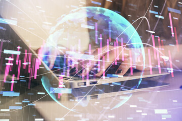 Double exposure of woman hands typing on computer and forex chart hologram drawing. Stock market invest concept.