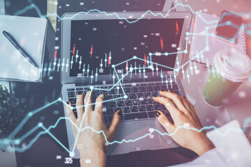 Double exposure of woman hands typing on computer and forex chart hologram drawing. Stock market invest concept.