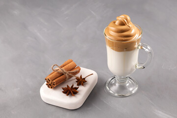 Homemade Dalgona coffee in glass with ingredients. Recipe popular Korean drink latte with foam of instant coffee. Cinnamon and spices are often added
