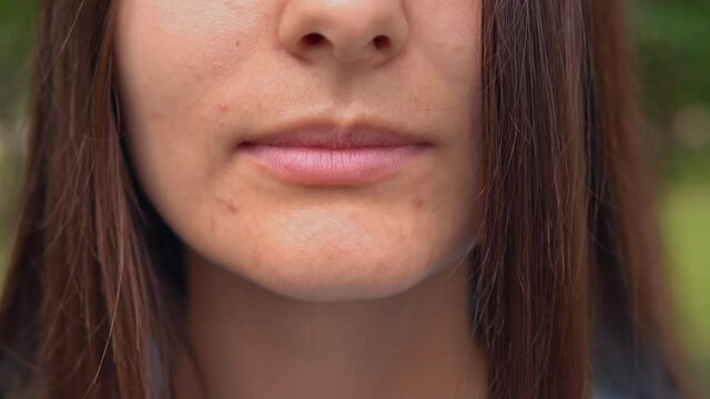 close up lower face young woman with long hair happy smiling slow motion