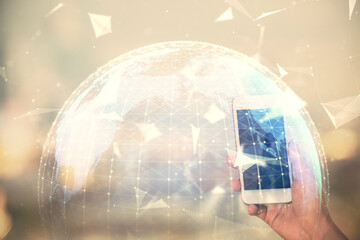 Double exposure of business theme sketch hologram and woman holding and using a mobile device.