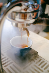 Espresso poruing from coffee machine