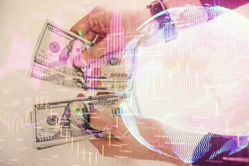 Multi exposure of financial graph drawing hologram and USA dollars bills and man hands. Analysis concept.