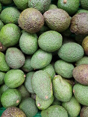 Drawers with avocados, fresh fruits on the market