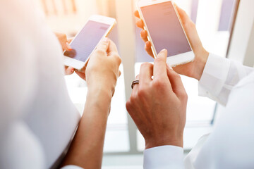  Females is reading on cell telephone financial news