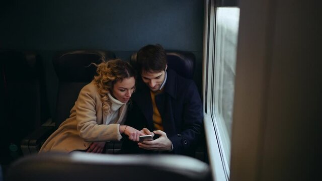 MS HA SELECTIVE FOCUS Couple traveling by train and using phone / Florence, Italy