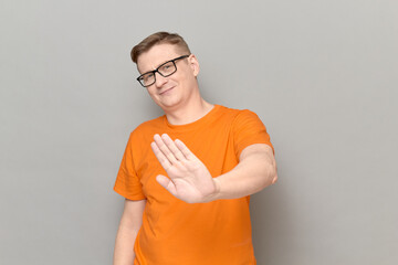 Portrait of optimistic man rejecting something, saying no or enough