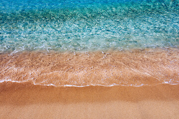 Yellow warm sand and summer sea with sky and free space. Sea, Sand, Sky and summer day. Beach and sea on a summer day, travel concept, vacation and relaxation. Summer sand beach and sea background.
