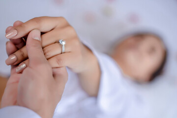 An unrecognizable bride and groom exchanging of the Wedding Rings in church during the christian wedding ceremony