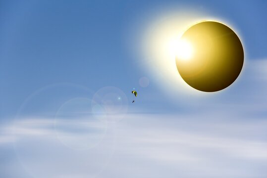 Eclipse of the sun bright spectacle , heavenly body background . Paraplan flies at sunset