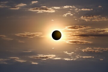 Colorful eclipse of the Sun in clouds sky , apocalypse sunset