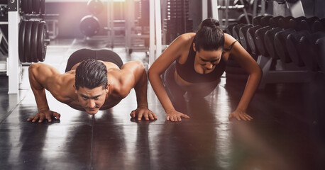 Fototapeta premium couple workout and exercise by push ups in gym and fitness health club