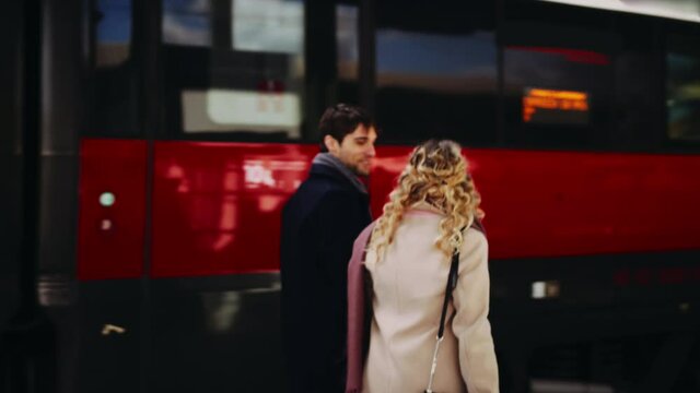 MS TS Young couple walking along train / Florence, Italy