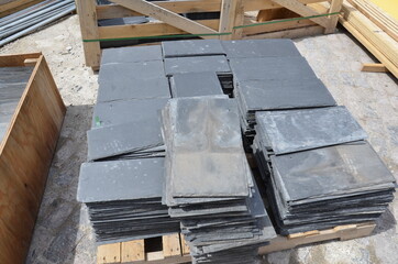 black tile rectangles building materials on ground