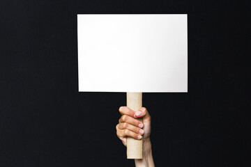 activist with an empty poster. protest banner on black background