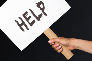 activist with a help poster. protest banner on black background
