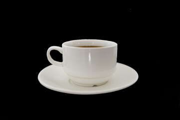 A white cup of coffee on a black background