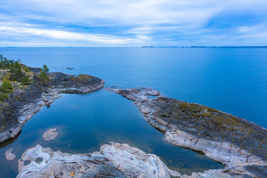 Panorama of Karelia from a height. The Russian landscape. Northern nature. View of lake Ladoga from the shore. Rocky coast of Ladoga. Karelian skerries. Travel to Russia.