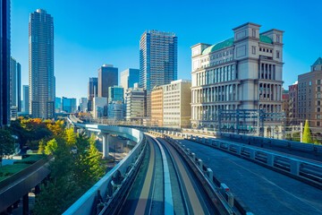 Obraz premium Cities of Japan. Business center of the Japanese capital. Office buildings and transport routes in Tokyo. Railway and road tracks in the center of the capital of Japan. Moving around Tokyo.