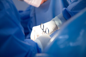 Medical team of surgeons in hospital doing caesarean