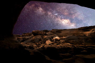 Milky Way with people on the mountain. Landscape with night sky with stars and silhouette of standing happy man and woman who pointing finger in starry sky. Milky way with travelers. Beautiful galaxy