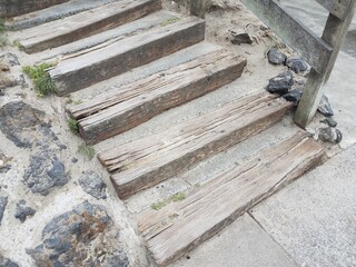 cement and wood steps with rocks or stones