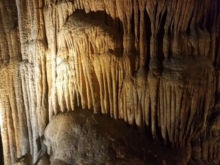 brown stalactites and stalagmites in cave or cavern