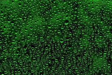 Closeup shot of raindrops isolated on a green background  - great for wallpapers © Sebastian Albin Fulvius/Wirestock