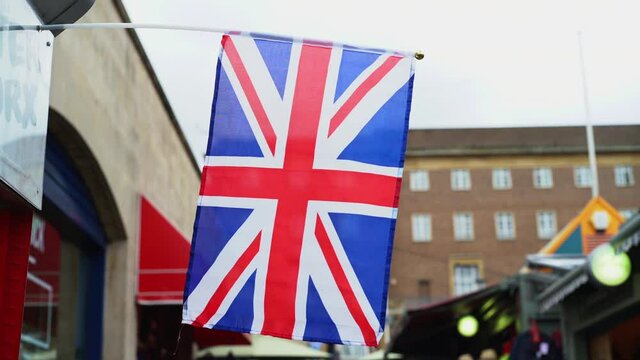 Close up of Union Jack flag outside Norwich market, England.