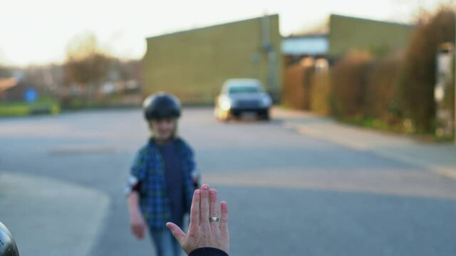 father and son skateboarding on a suburban street.