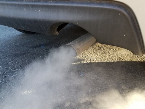 Car Exhaust Or Smoke And Black Asphalt