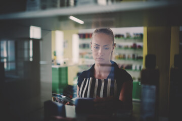 Young Caucasian woman shop owner enjoying entrepreneurship business