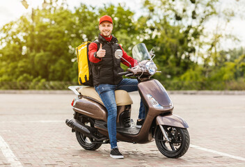 Fototapeta na wymiar Courier Gesturing Thumbs-Up Approving Food Delivery Sitting On Motorbike Outdoor