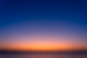 Beautiful blurred sky before sunrise with a natural gradient of orange and blue sky background.