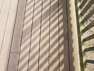 brown wood deck with shadow on boards