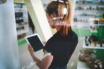 Young Caucasian woman shop owner enjoying entrepreneurship business