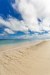 Deserted sandy beach and blue sky and ocean