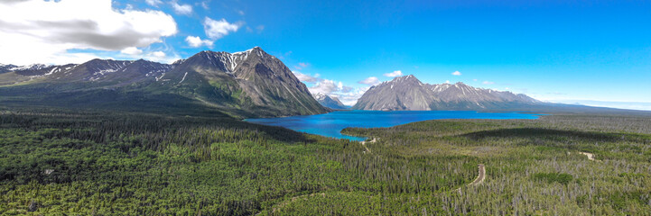 Naklejka na ściany i meble Amazing & pristine Kathleen Lake in Yukon Territory, northern Canada. Taken in the warm, stunning summer months. Bright blue water with huge mountains. 