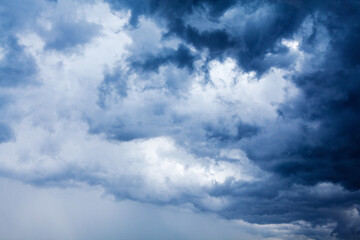 Stormy cloudy sky closeup, dark blue thunderclouds, white cumulus clouds, rainy thunderstorm...