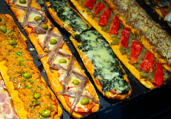 Cocas with vegetables, meat and fish